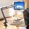 A black adjustable tablet computer holder with a long arm is positioned over a wooden table.