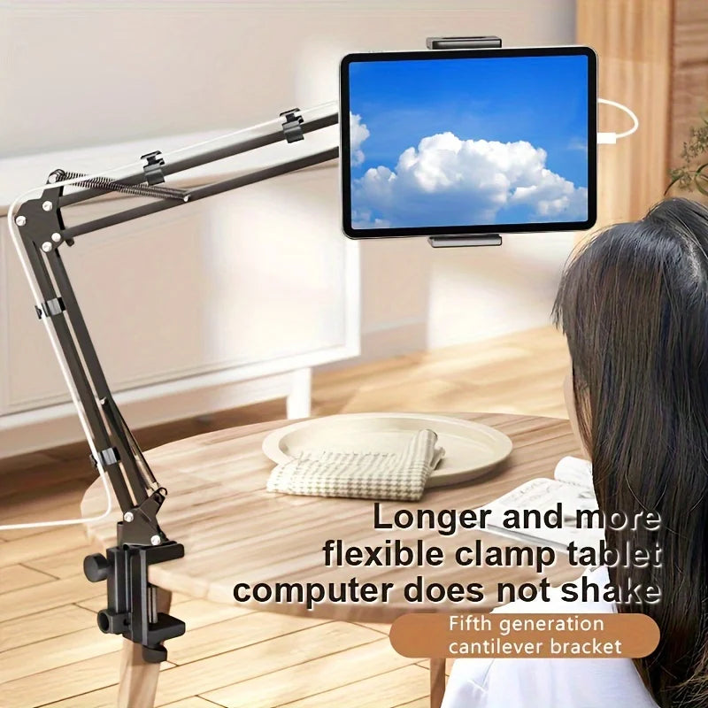 A black adjustable tablet computer holder with a long arm is positioned over a wooden table.