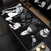 A black mouse pad featuring a monochrome illustration of a person with long hair and intense facial features.