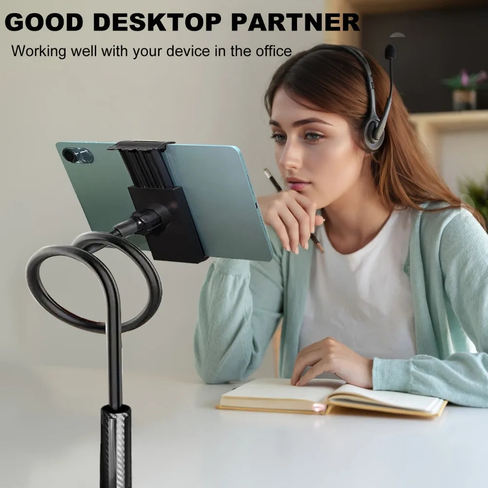 A woman is using a 360° rotating tablet and phone stand with a flexible spiral base on a desk.