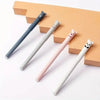 A set of five panda-themed erasable gel pens with various colors and finishes displayed on a light orange background.