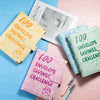 A set of pink and green marble budget binders with envelopes for savings challenges displayed on a pastel background.