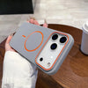 A hand holds a gray magnetic wireless charging phone case with an orange circular design on the back.