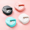 Three precision corner cutters in pink, black, and light blue are displayed on a pink background.