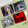 A collection of Junji Ito Tomie mouse pads featuring various illustrations and designs.