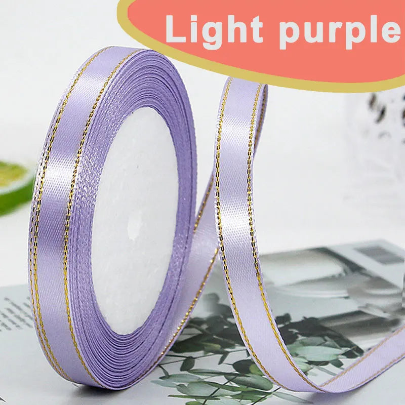 Roll of light purple satin ribbon with gold edges