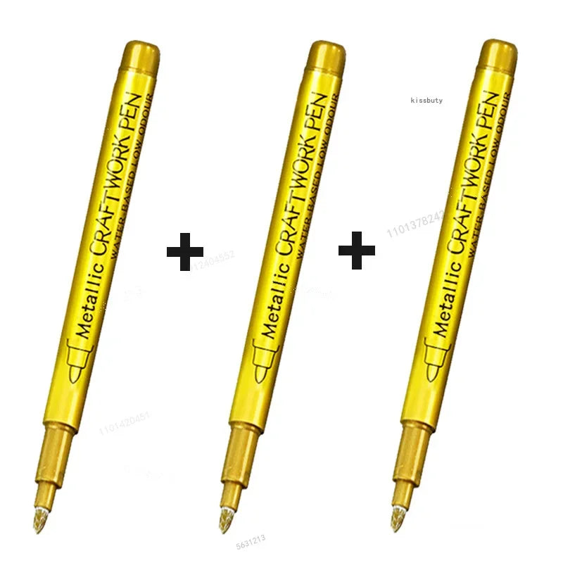 Three metallic craft work pen markers shown in yellow and gold, angled for display.