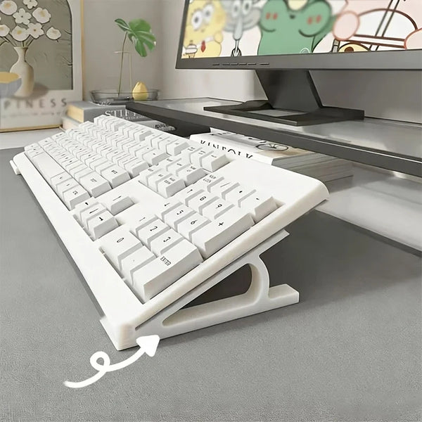 A white ergonomic keyboard height increasing stand is shown on a desk in front of a computer monitor.