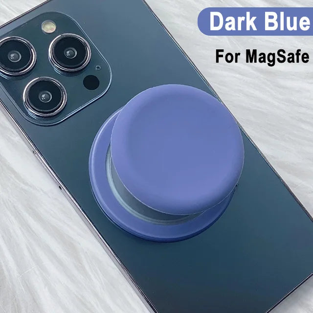 A dark blue phone case with a purple silicone magnetic grip cover shown on a white surface.