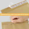 A hand is sealing a kraft paper bubble mailer with a clear tamperproof seal.