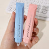 A hand holds a pink gradient double-sided tape pen labeled good luck gluetape.