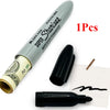 A silver marker pen with a hidden compartment is shown next to several black marker pens on white paper.
