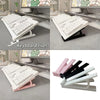Two white and pink ergonomic keyboard risers shown from different angles.