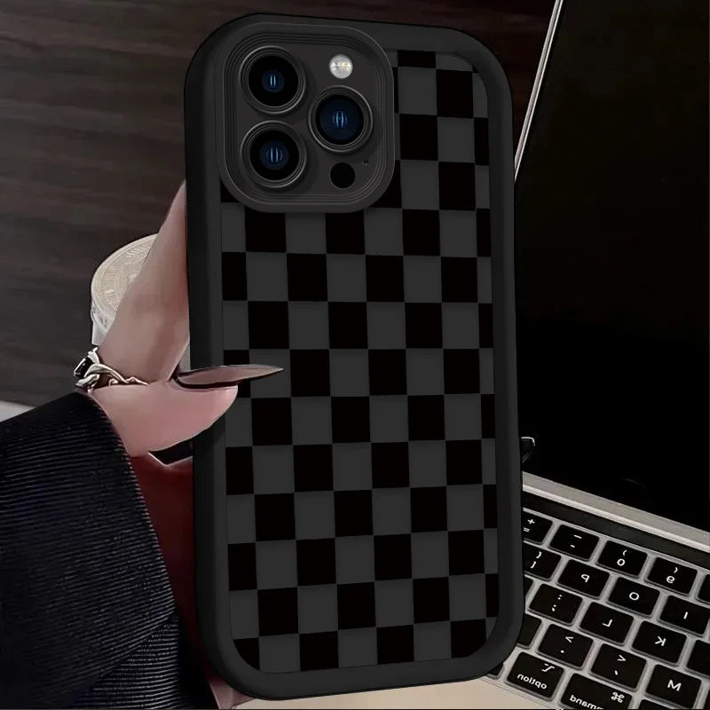 A black and white checkered silicone phone case is shown on a smartphone, held by a hand.