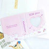 A pink hollow photo card binder with a heart-shaped clear window and cute illustrations.
