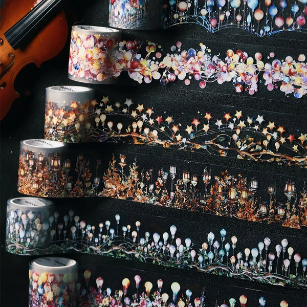 A collection of decorative PET washi tape rolls featuring floral, starry, and botanical designs for crafting.
