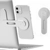 A silver magnetic phone holder is attached to a laptop, with a separate clip shown nearby.
