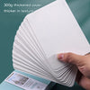 A stack of 300g thickened paper watercolor postcards is shown being held by a hand.