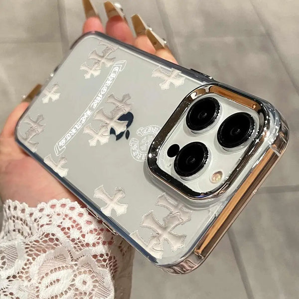 A hand holds a holographic gradient phone case for an iPhone with gold nail polish and white lace sleeve visible.