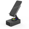 A black wireless speaker with an adjustable phone stand and a colored night light base.