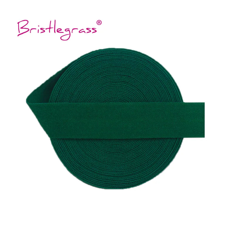 A dark green elastic hair tie or trim, coiled and laid flat.