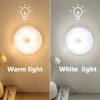 A comparison showing warm light and white light versions of a round LED night light, highlighting the difference in illuminat