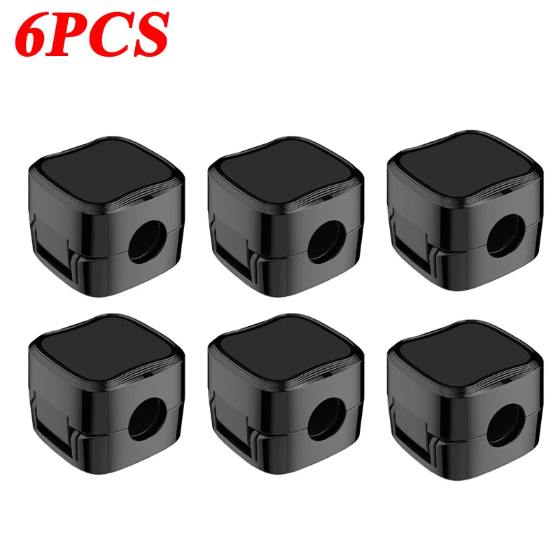 Six black magnetic cable clips designed for desk organization.