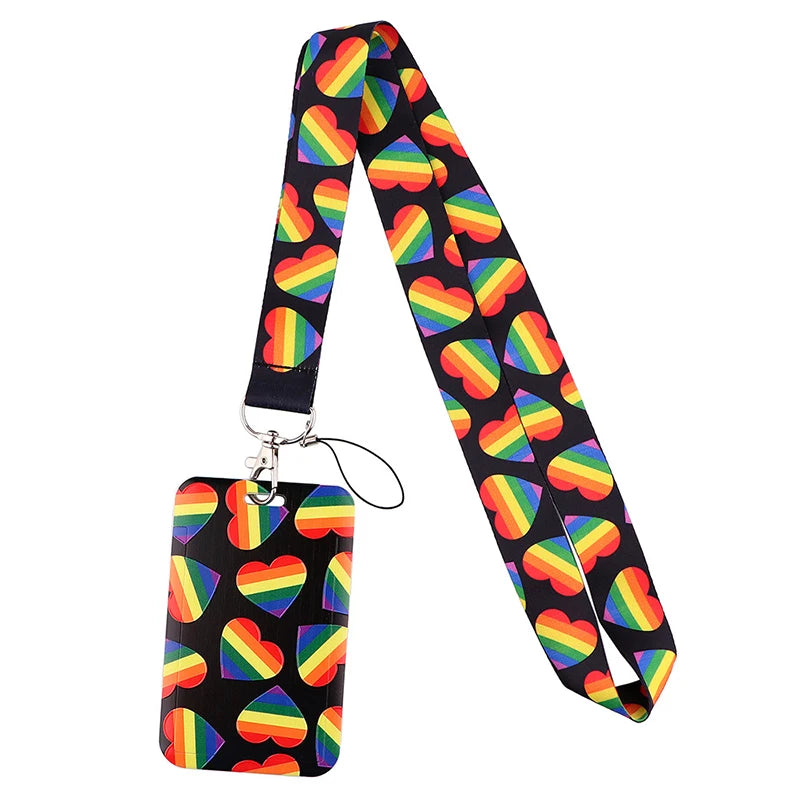 A black lanyard with a rainbow pattern, featuring a heart-shaped charm for ID badges and accessories.