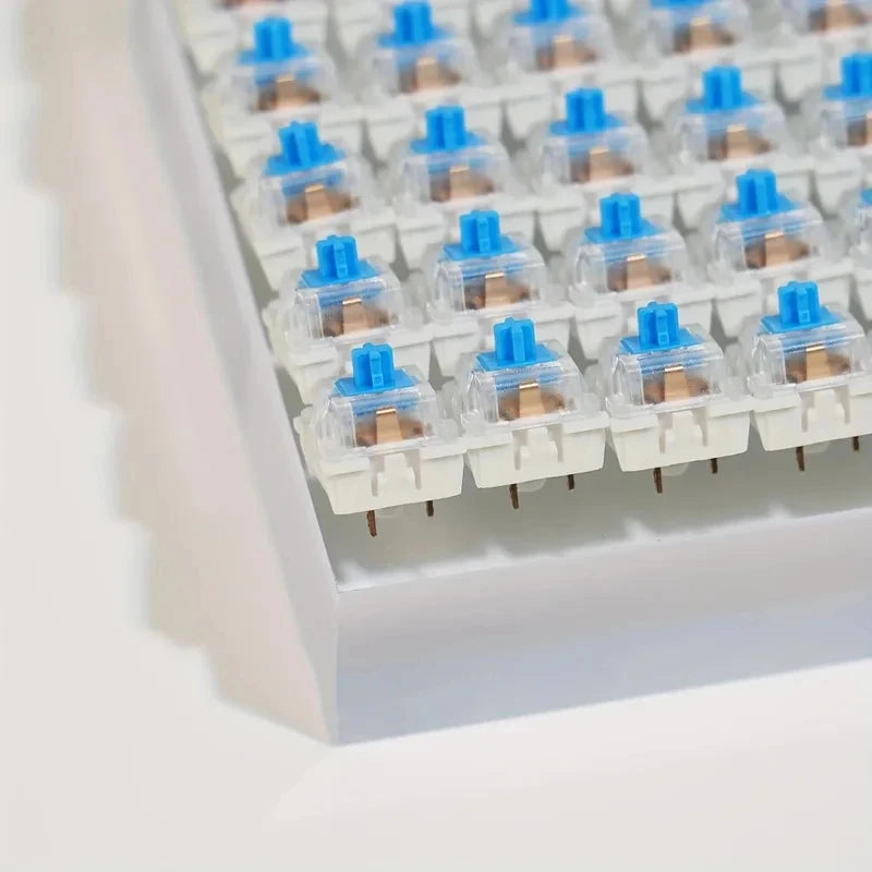 A close-up view of a tray containing hot-swappable mechanical keyboard switches with keycap pullers.