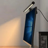 An LED monitor light bar is mounted on a wall, casting a bright light onto a surface.