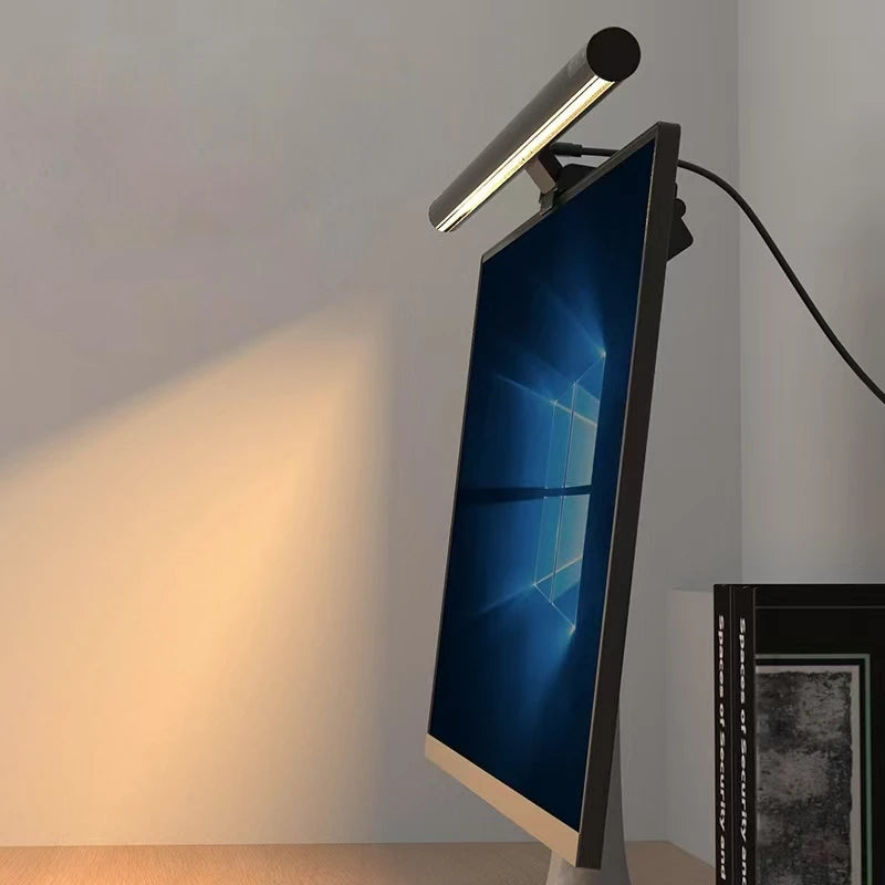 An LED monitor light bar is mounted on a wall, casting a bright light onto a surface.