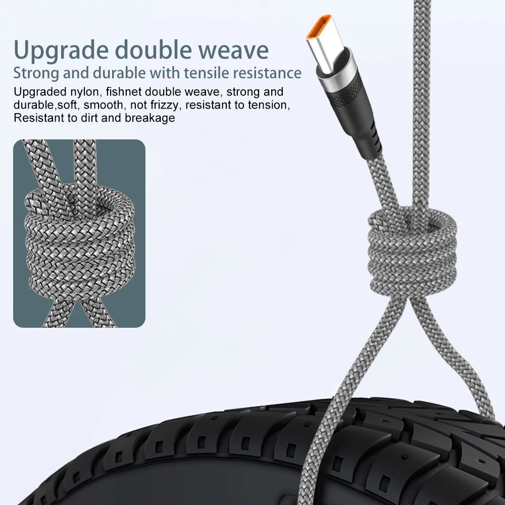 A close-up of a braided nylon charging cable with an orange connector being tied around a tire.