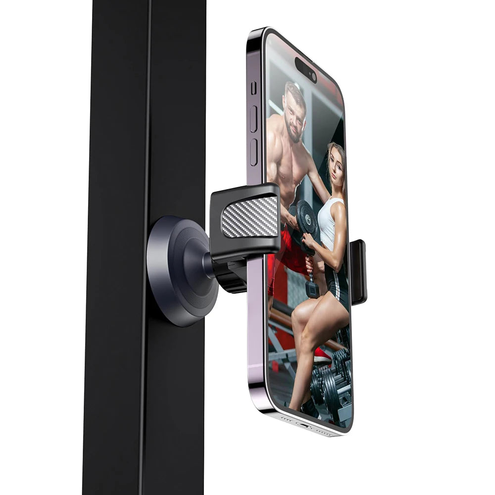 A black magnetic phone holder is attached to a black door, displaying a fitness model on the phone screen.