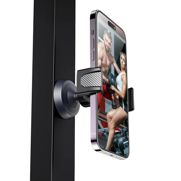 A black magnetic phone holder is attached to a black door, displaying a fitness model on the phone screen.
