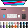 A large pink desk mat featuring various color circles for a laptop and keyboard.