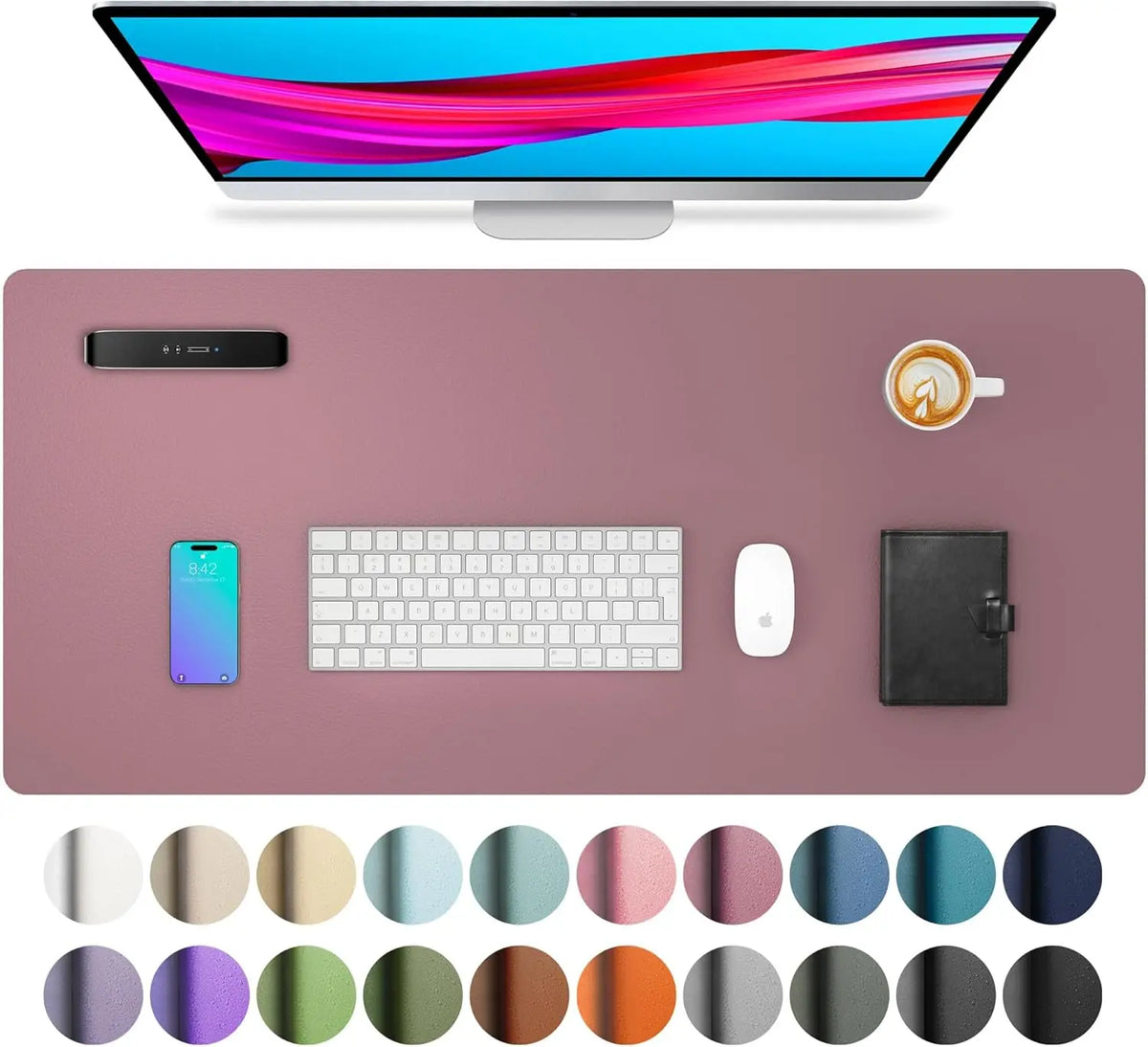 A large pink desk mat featuring various color circles for a laptop and keyboard.