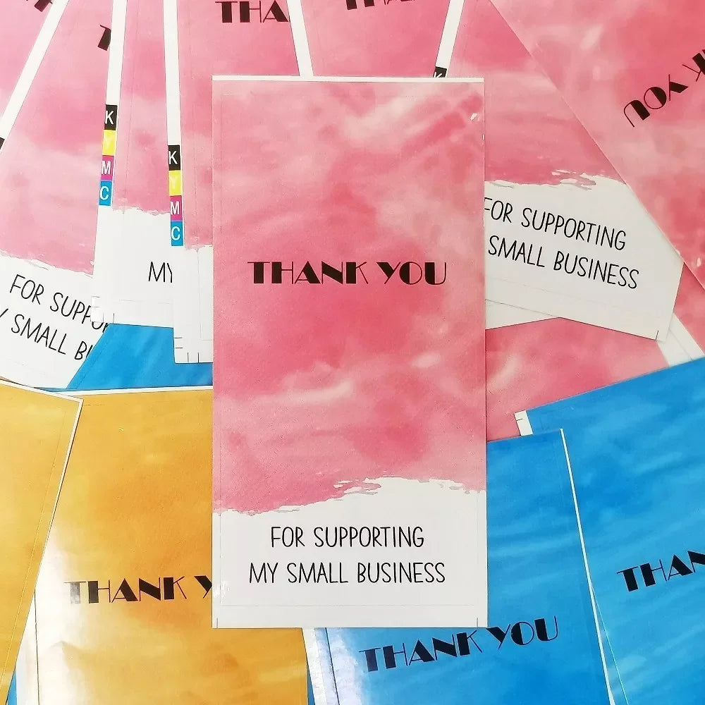 A collection of rectangular thank you gift stickers in pink, yellow, and blue shades.