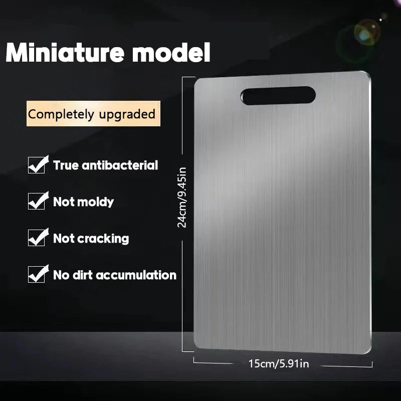 A silver stainless steel miniature cutting board with upgrade features shown against a dark background.