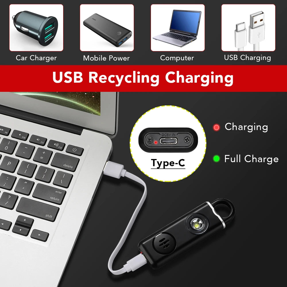 A black personal safety alarm device is shown connected to a laptop via a USB Type-C cable for charging.