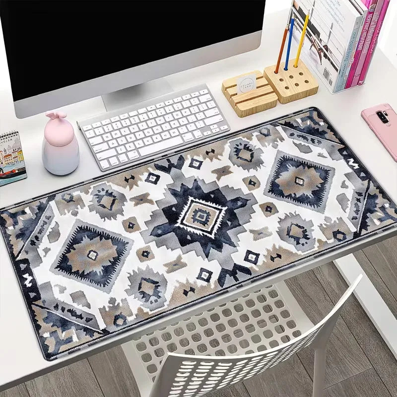 A vintage Persian rug gaming mouse pad with a non-slip rubber base is displayed on a desk.