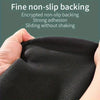 Close-up of a black non-slip backing fabric being held by a hand.
