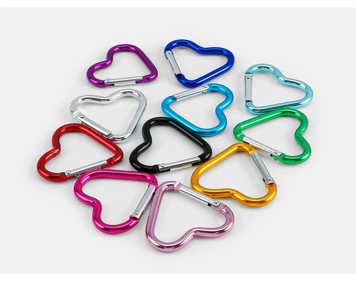 A collection of five colorful heart-shaped spring clasps and carabiner keychains in various colors like purple, blue, silver,