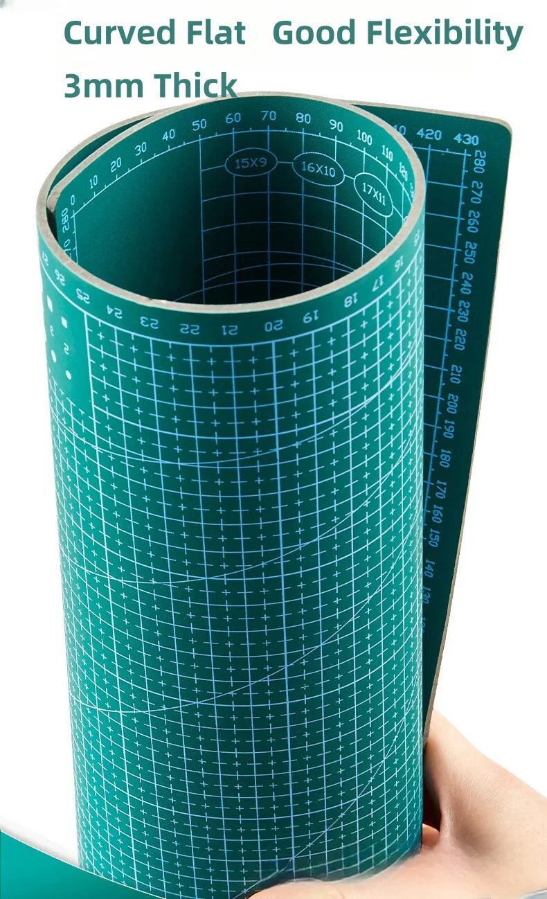 A roll of 3mm thick curved flat green cutting mat with measurement markings.
