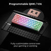 A close-up view of a programmable QMK/VIA mechanical keyboard with RGB lighting and a pink mousepad in the background.