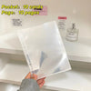 A clear plastic sleeve holding ten cards and a pink notebook page on a white shelf