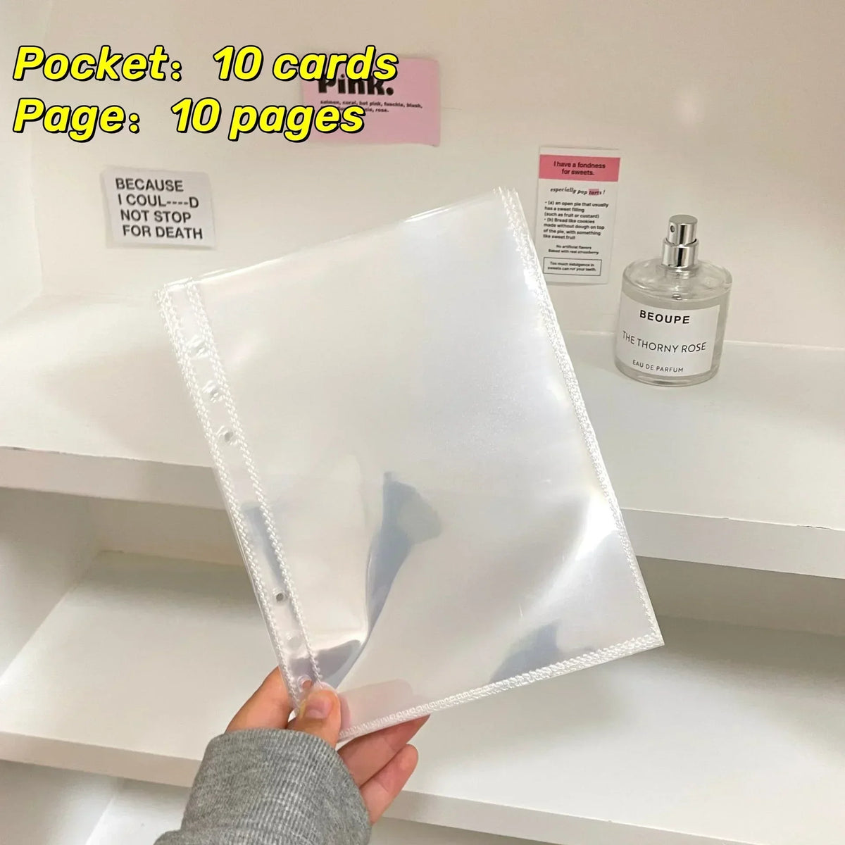 A clear plastic sleeve holding ten cards and a pink notebook page on a white shelf
