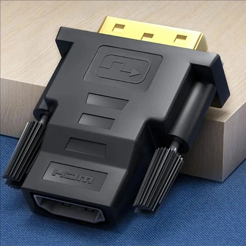 A black DVI to HDMI bi-directional adapter cable resting on a blue surface next to a yellow connector.