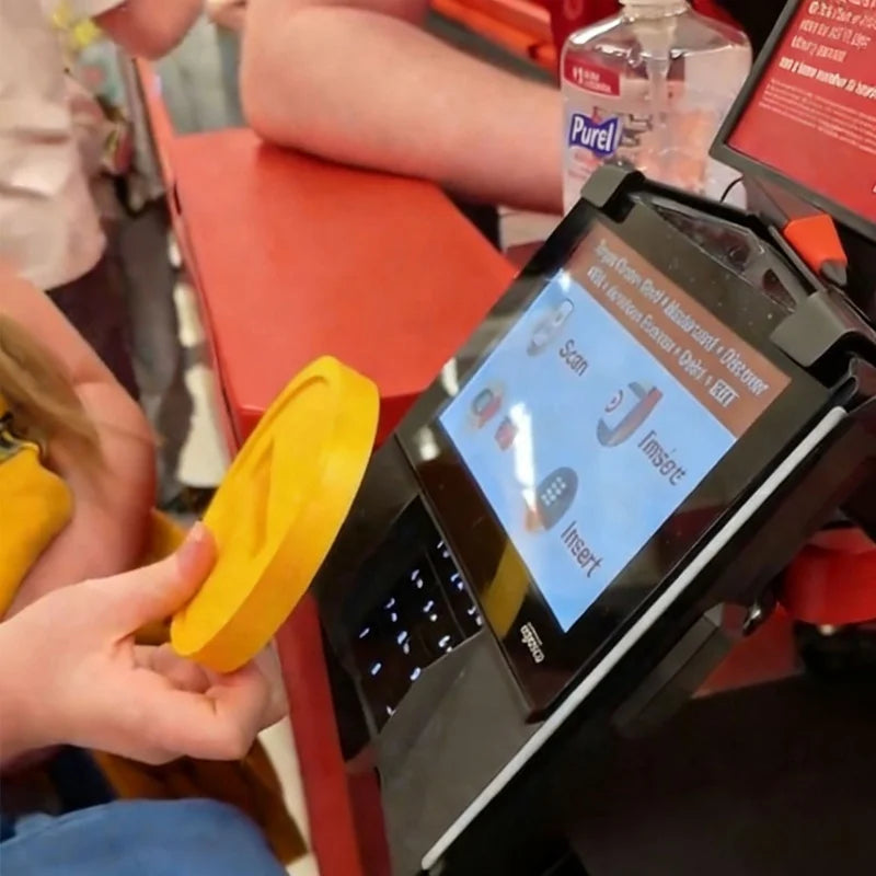 A hand inserts a card into a black electronic device for tap-to-pay using an NFC technology.