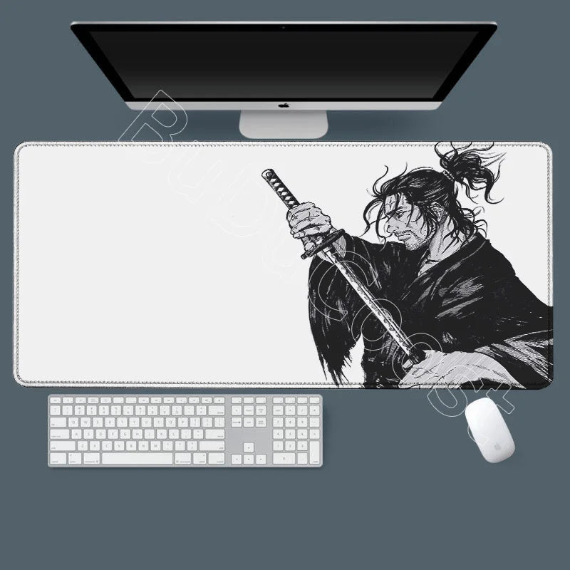 A black and white illustration of Miyamoto Musashi from Vagabond manga on a gaming mousepad with a computer setup.