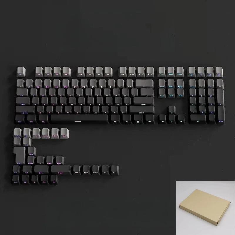 A close-up view of a black mechanical keyboard with gradient gray double shot PBT keycaps and side printing.